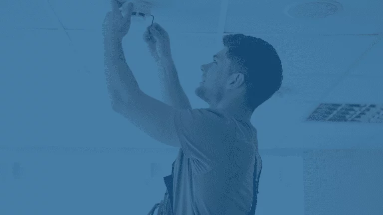 guy checking the smoke alarm